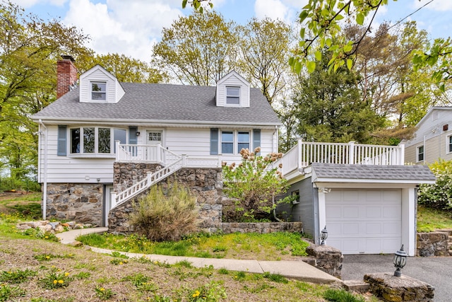 cape cod home with aphalt driveway, stairs, roof with shingles, a wooden deck, and a chimney
