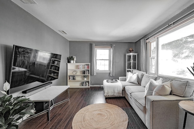 living area with visible vents and dark wood-type flooring