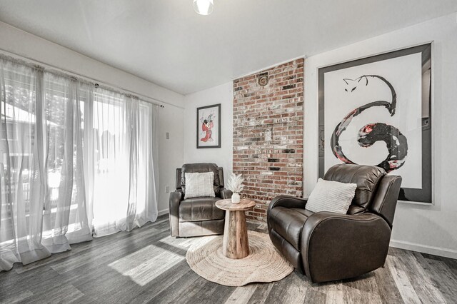 living area featuring baseboards and wood finished floors
