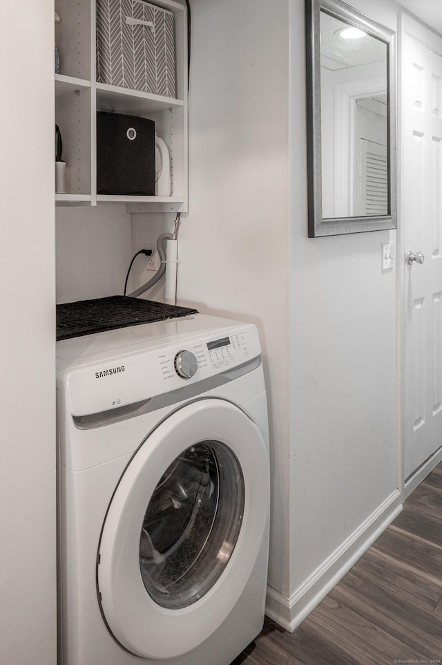 washroom with baseboards, laundry area, dark wood-style floors, and washer / clothes dryer