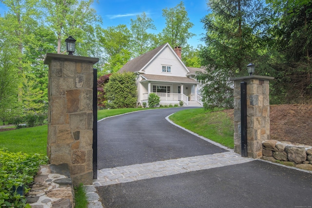 72 S Salem Rd, Ridgefield, CT 06877 - view of front of house with a chimney, covered porch, and driveway