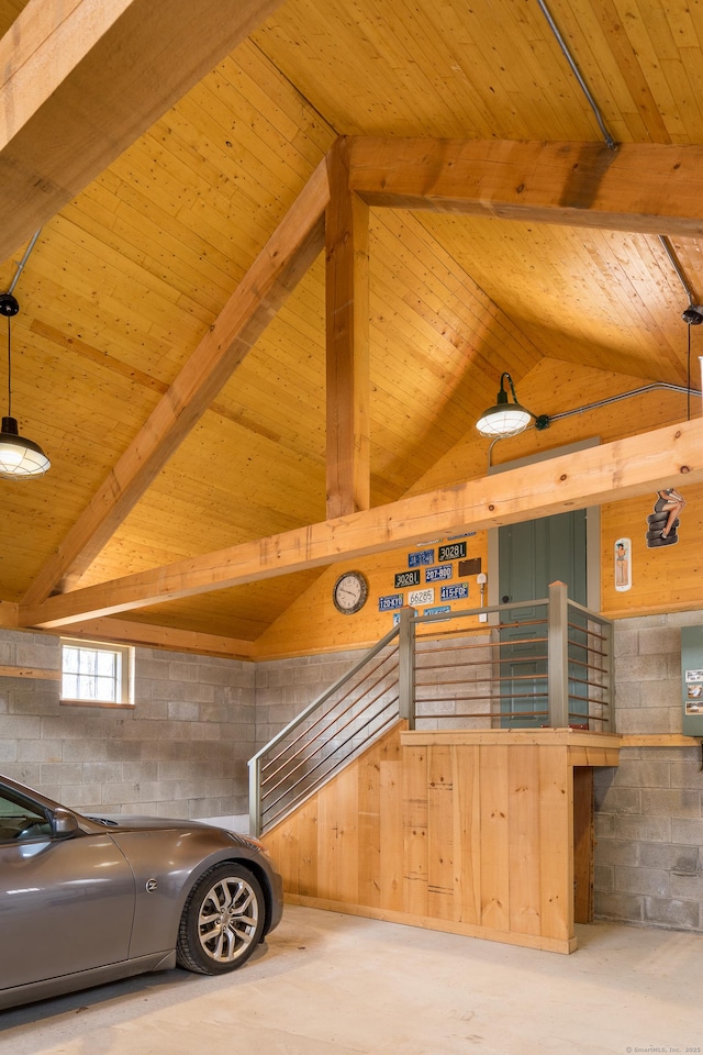 details featuring wooden ceiling, concrete flooring, beamed ceiling, and concrete block wall