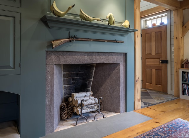 details with a fireplace and wood finished floors