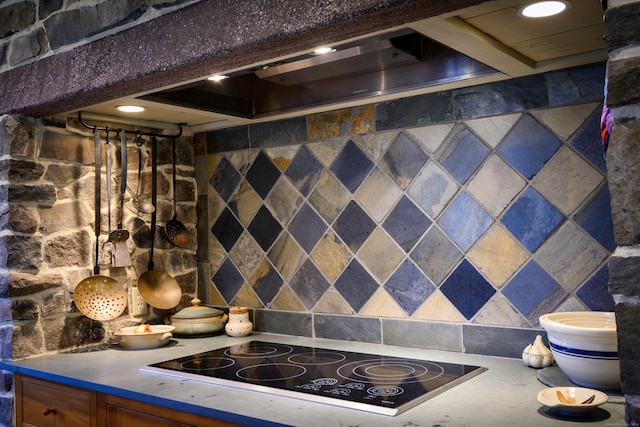 room details with wall chimney exhaust hood, black electric stovetop, and recessed lighting