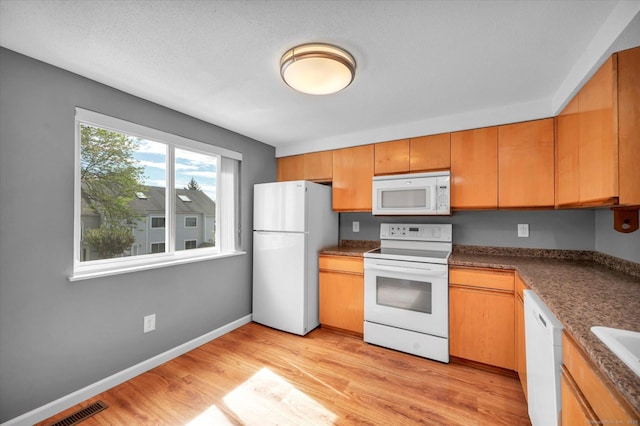 37 Valley Run Dr Unit 37, Cromwell, CT 06416 - kitchen featuring white appliances, light wood-style floors, dark countertops, and baseboards
