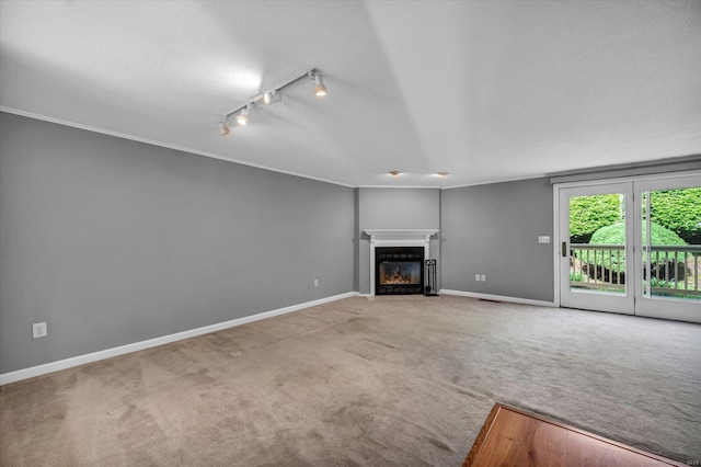 37 Valley Run Dr Unit 37, Cromwell, CT 06416 - unfurnished living room with rail lighting, carpet floors, a fireplace with flush hearth, baseboards, and a textured ceiling
