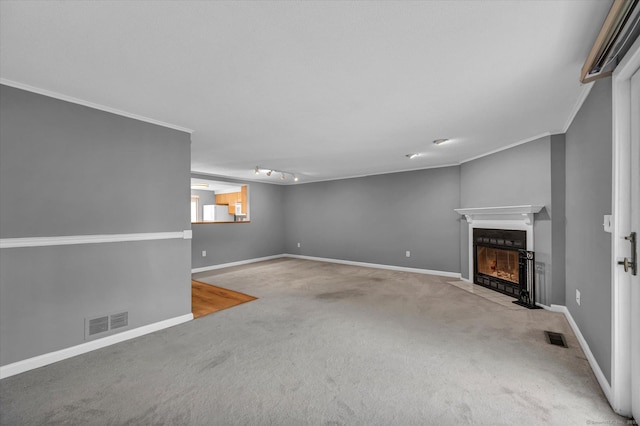 37 Valley Run Dr Unit 37, Cromwell, CT 06416 - unfurnished living room with carpet flooring, a fireplace with flush hearth, baseboards, ornamental molding, and rail lighting