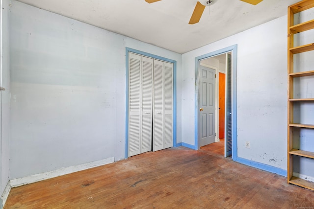 unfurnished bedroom with baseboards, a closet, ceiling fan, and wood finished floors