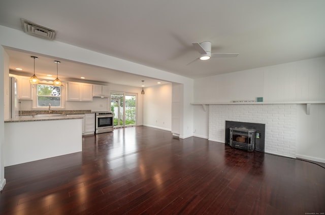 14 Bassett Rd, Branford, CT 06405 - unfurnished living room featuring a ceiling fan, dark wood finished floors, a sink, and baseboards
