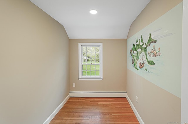 unfurnished room with light wood-style flooring, baseboards, vaulted ceiling, a baseboard radiator, and recessed lighting