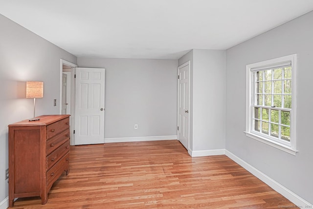unfurnished bedroom featuring baseboards and light wood-style floors