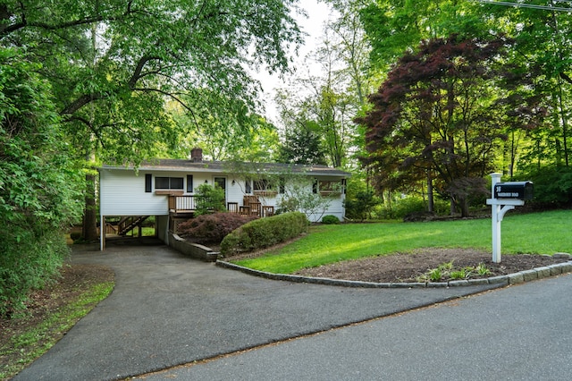 16 Wakerobin Rd, Norwalk, CT 06851 - ranch-style house with a front yard, driveway, a carport, and a chimney