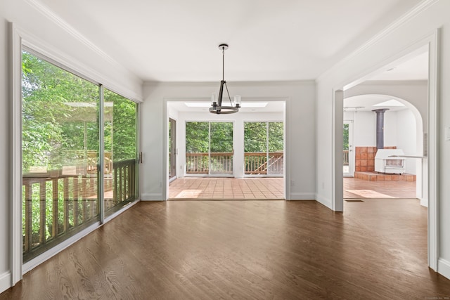 16 Wakerobin Rd, Norwalk, CT 06851 - unfurnished dining area with plenty of natural light, wood finished floors, arched walkways, and ornamental molding