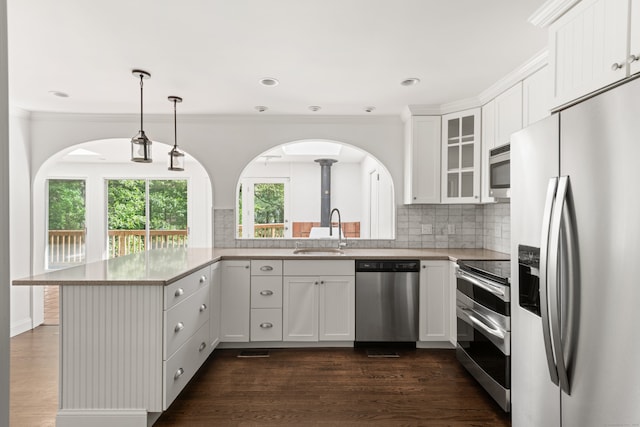 16 Wakerobin Rd, Norwalk, CT 06851 - kitchen featuring stainless steel appliances, a sink, glass insert cabinets, white cabinetry, and tasteful backsplash