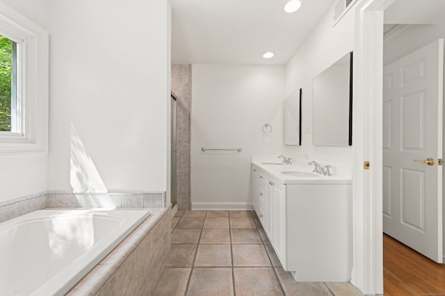 16 Wakerobin Rd, Norwalk, CT 06851 - full bath with double vanity, a garden tub, a stall shower, recessed lighting, and baseboards