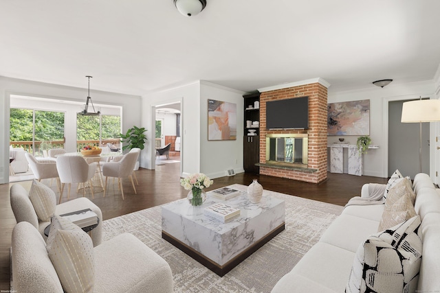 16 Wakerobin Rd, Norwalk, CT 06851 - living room featuring wood finished floors, ornamental molding, baseboards, and a brick fireplace