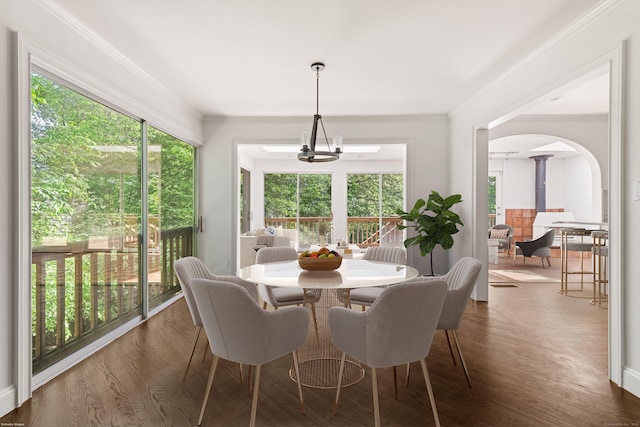 16 Wakerobin Rd, Norwalk, CT 06851 - dining room with ornate columns, healthy amount of natural light, arched walkways, crown molding, and dark wood finished floors