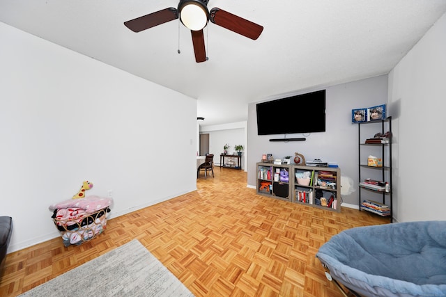 interior space with baseboards and ceiling fan