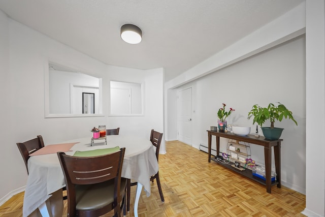 dining space with baseboards and a baseboard heating unit