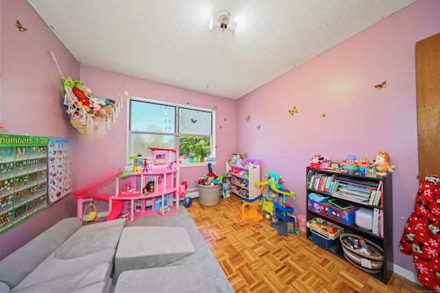 playroom featuring a textured ceiling