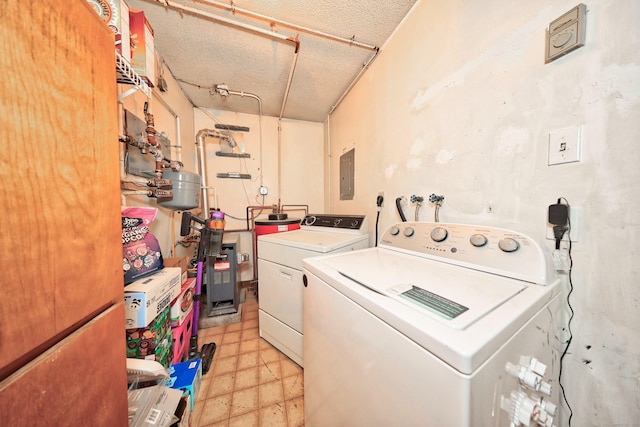 washroom with laundry area, a textured ceiling, washer and dryer, light floors, and a heating unit