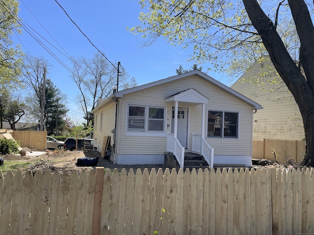 bungalow-style house with fence private yard
