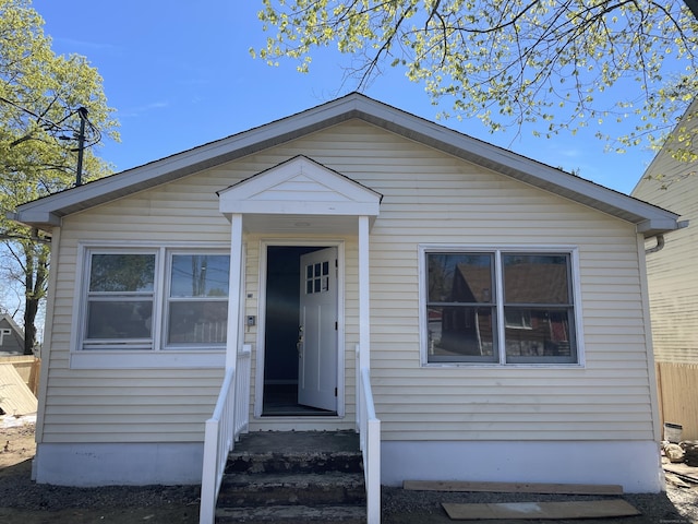 bungalow-style house featuring fence and entry steps