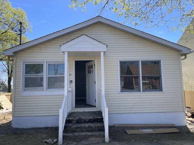 bungalow featuring fence and entry steps