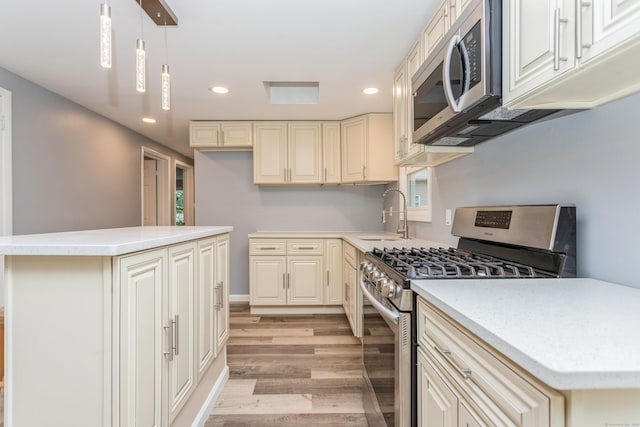 75 Edwards St, Bridgeport, CT 06606 - kitchen featuring stainless steel appliances, a sink, light wood-type flooring, recessed lighting, and light countertops