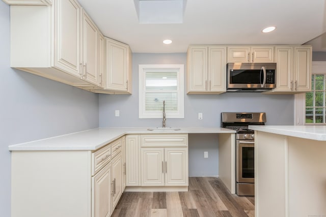 75 Edwards St, Bridgeport, CT 06606 - kitchen featuring appliances with stainless steel finishes, a sink, light wood-style flooring, recessed lighting, and light countertops