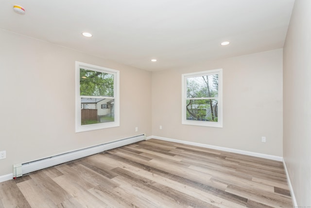 75 Edwards St, Bridgeport, CT 06606 - unfurnished room with a baseboard heating unit, plenty of natural light, wood finished floors, baseboards, and recessed lighting