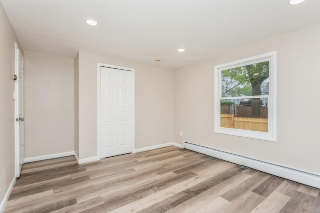 75 Edwards St, Bridgeport, CT 06606 - unfurnished bedroom featuring baseboard heating, light wood-style floors, baseboards, recessed lighting, and a closet