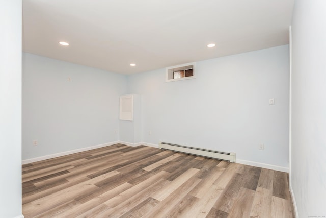 75 Edwards St, Bridgeport, CT 06606 - below grade area with baseboard heating, wood finished floors, recessed lighting, and baseboards