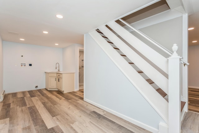75 Edwards St, Bridgeport, CT 06606 - clothes washing area with washer hookup, electric dryer hookup, recessed lighting, light wood-type flooring, and a baseboard heating unit