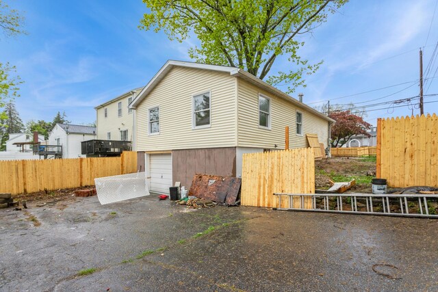 75 Edwards St, Bridgeport, CT 06606 - view of home's exterior with driveway, fence, and a garage