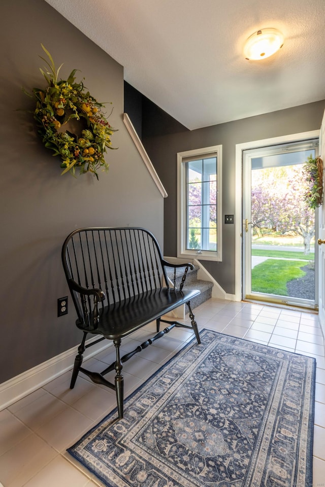interior space featuring baseboards and light tile patterned flooring