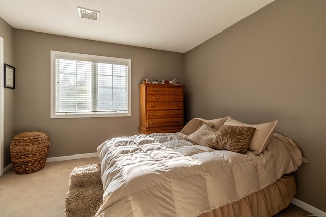 bedroom with baseboards, visible vents, and carpet