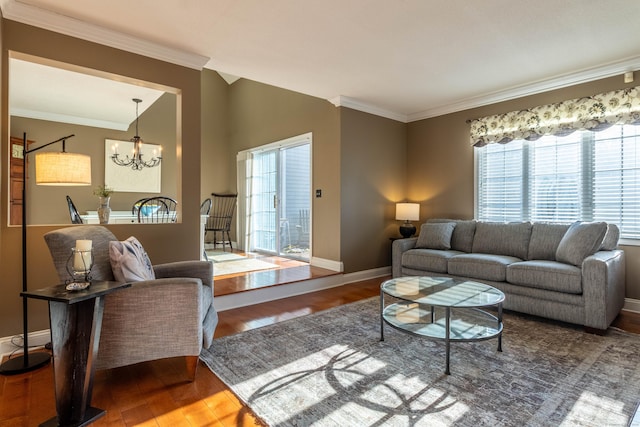 living room with crown molding, an inviting chandelier, a healthy amount of sunlight, and wood finished floors