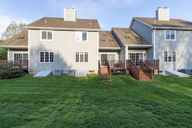 back of property featuring a yard, cooling unit, and a wooden deck