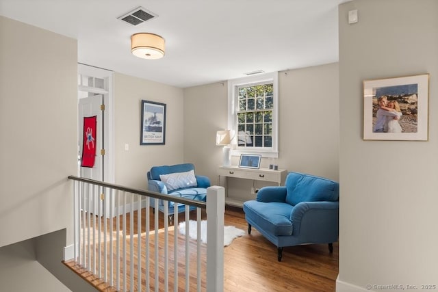 living area with wood finished floors and baseboards