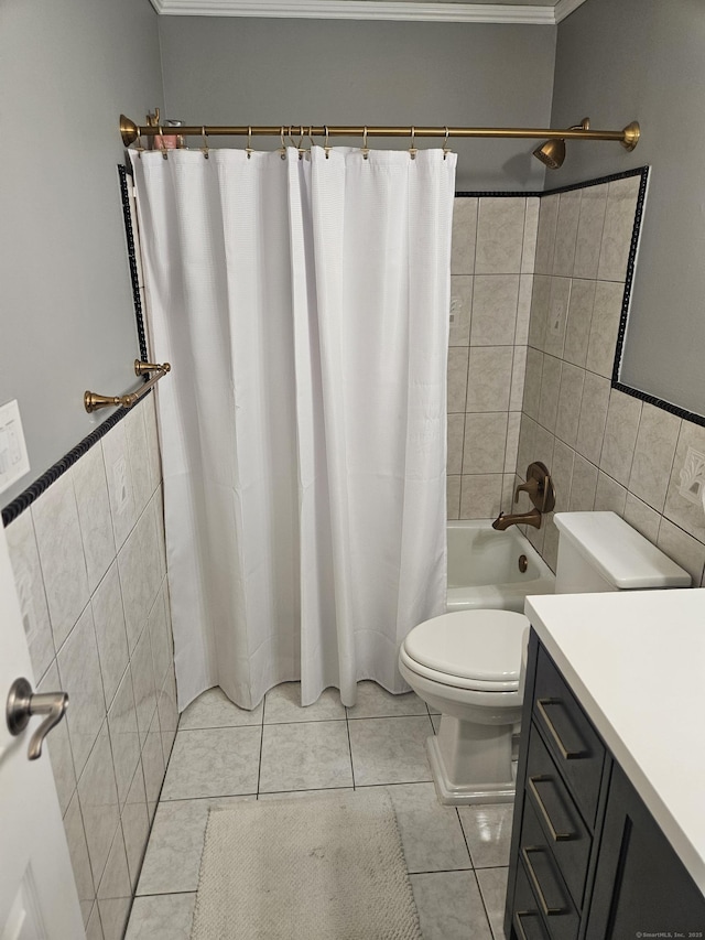 full bath featuring tile patterned flooring, shower / tub combo with curtain, vanity, toilet, and tile walls