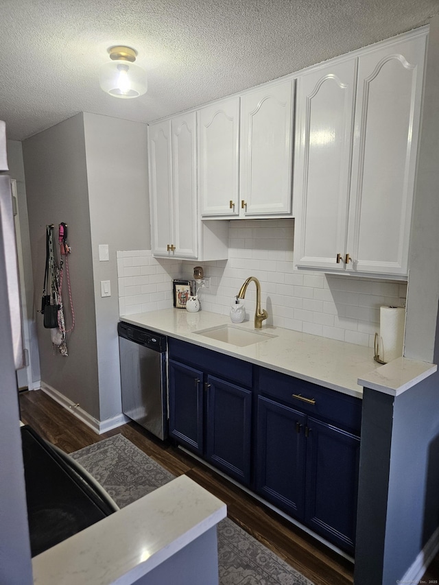 kitchen with white cabinets, a sink, dishwasher, dark wood-type flooring, and blue cabinets