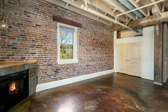 43 Chestnut St Unit 106, New Haven, CT 06511 - unfurnished living room with finished concrete flooring, a warm lit fireplace, and brick wall