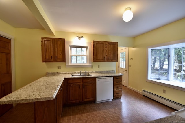 kitchen featuring white dishwasher, light countertops, a baseboard heating unit, brown cabinets, and a sink