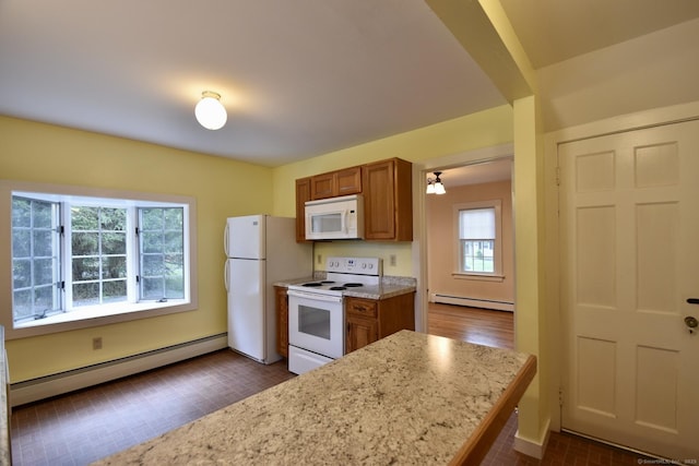 kitchen featuring brown cabinetry, a baseboard heating unit, white appliances, and light stone countertops