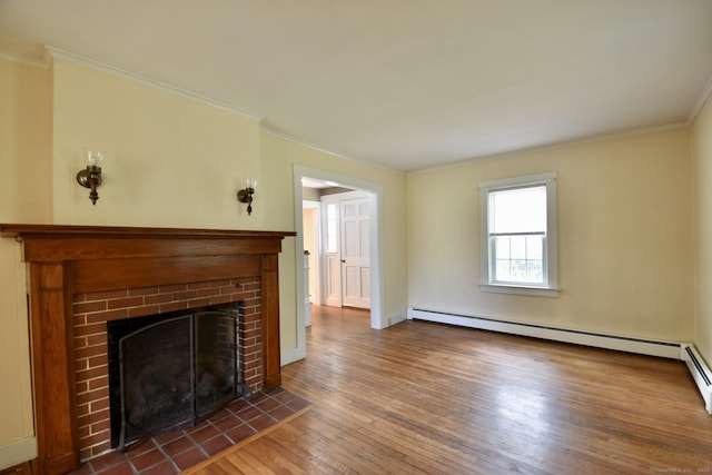 unfurnished living room with a fireplace, a baseboard heating unit, ornamental molding, and hardwood / wood-style floors