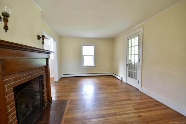unfurnished living room with a baseboard radiator, ornamental molding, wood finished floors, and a healthy amount of sunlight