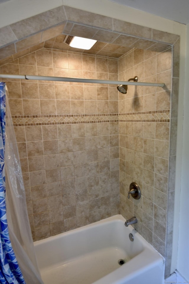 bathroom with shower / bath combo with shower curtain