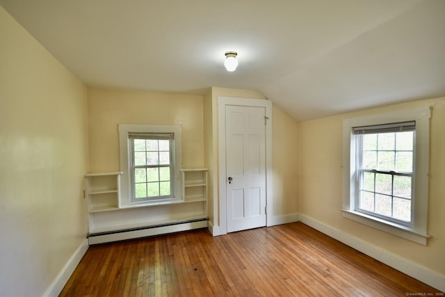 bonus room featuring wood-type flooring, baseboards, lofted ceiling, and baseboard heating