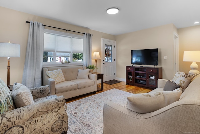 living area featuring baseboards and wood finished floors